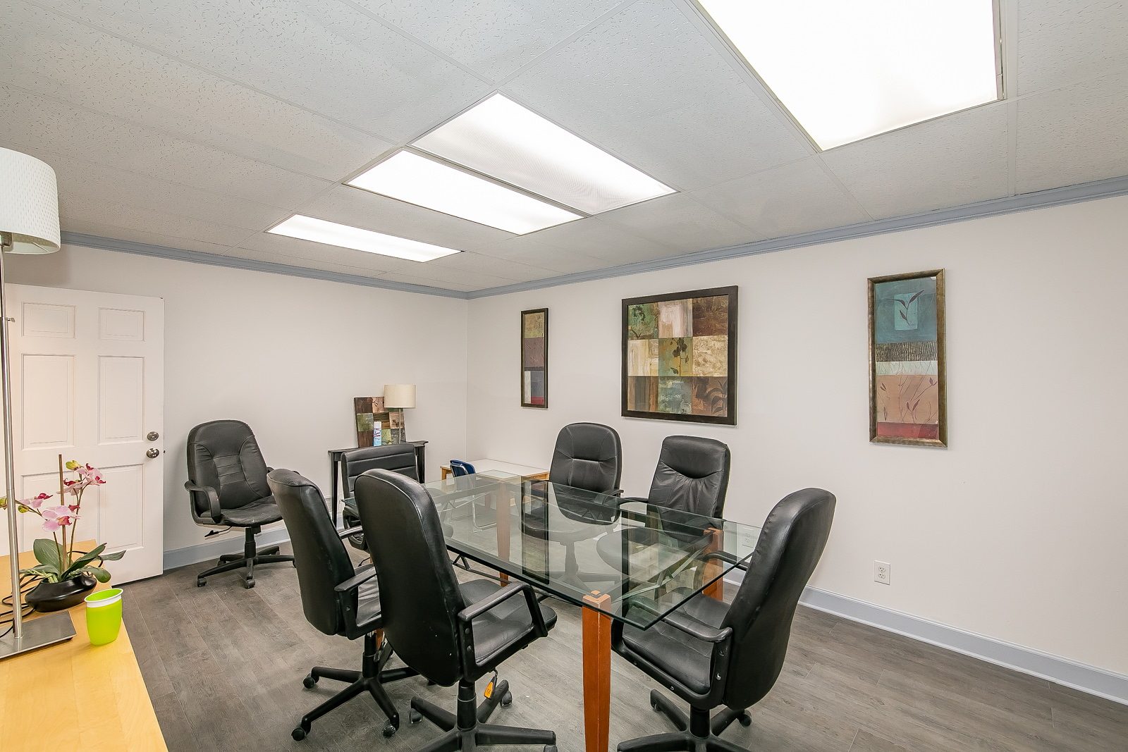 Conference room with glass table and black chairs