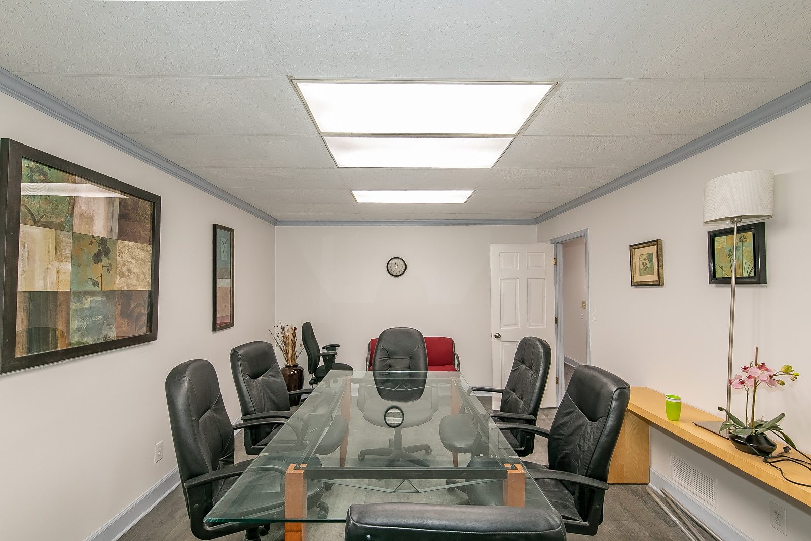 Conference room with wall art and a glass meeting table